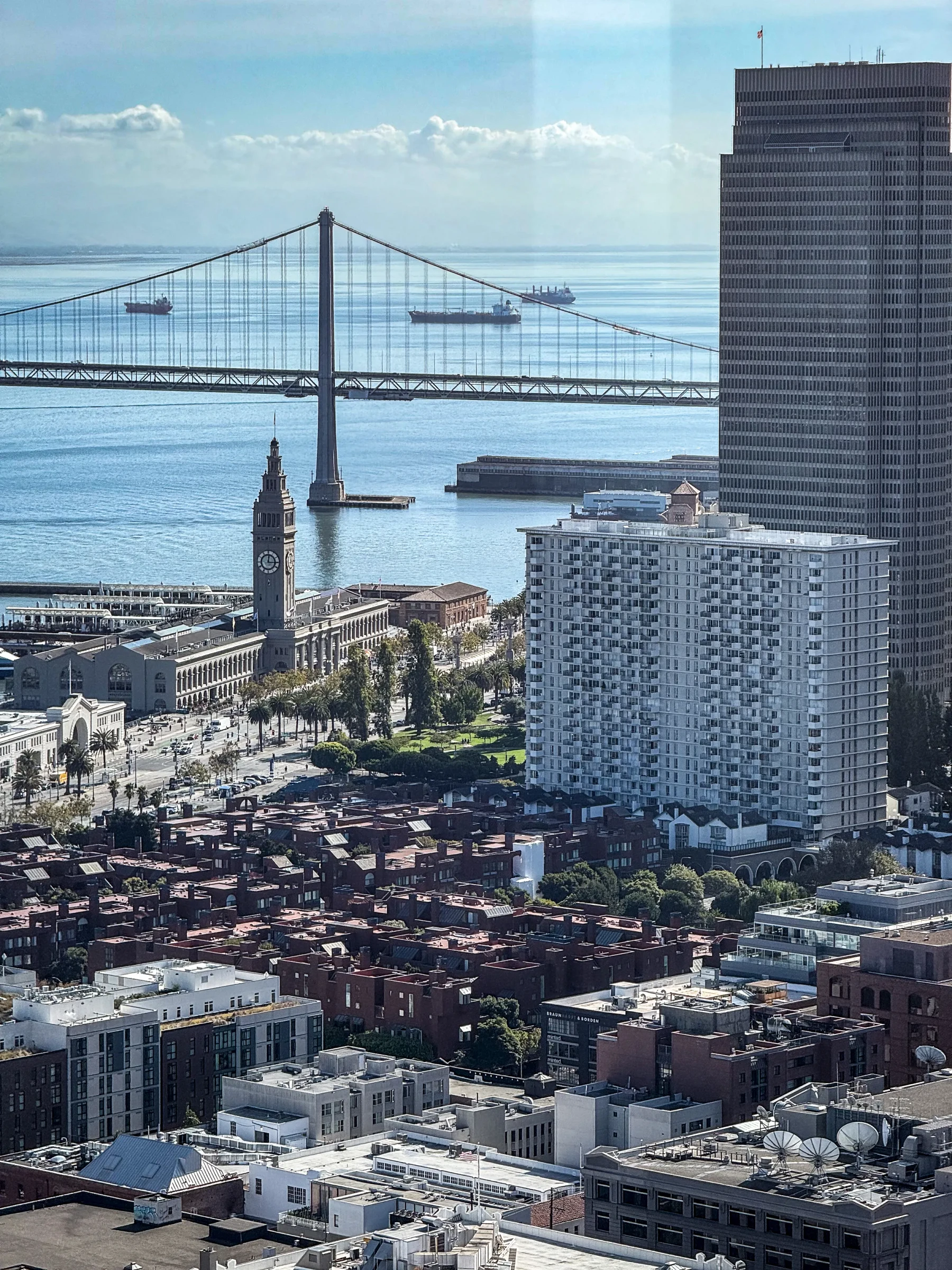 A view of San Francisco buildings and the Bay Bridge from above.