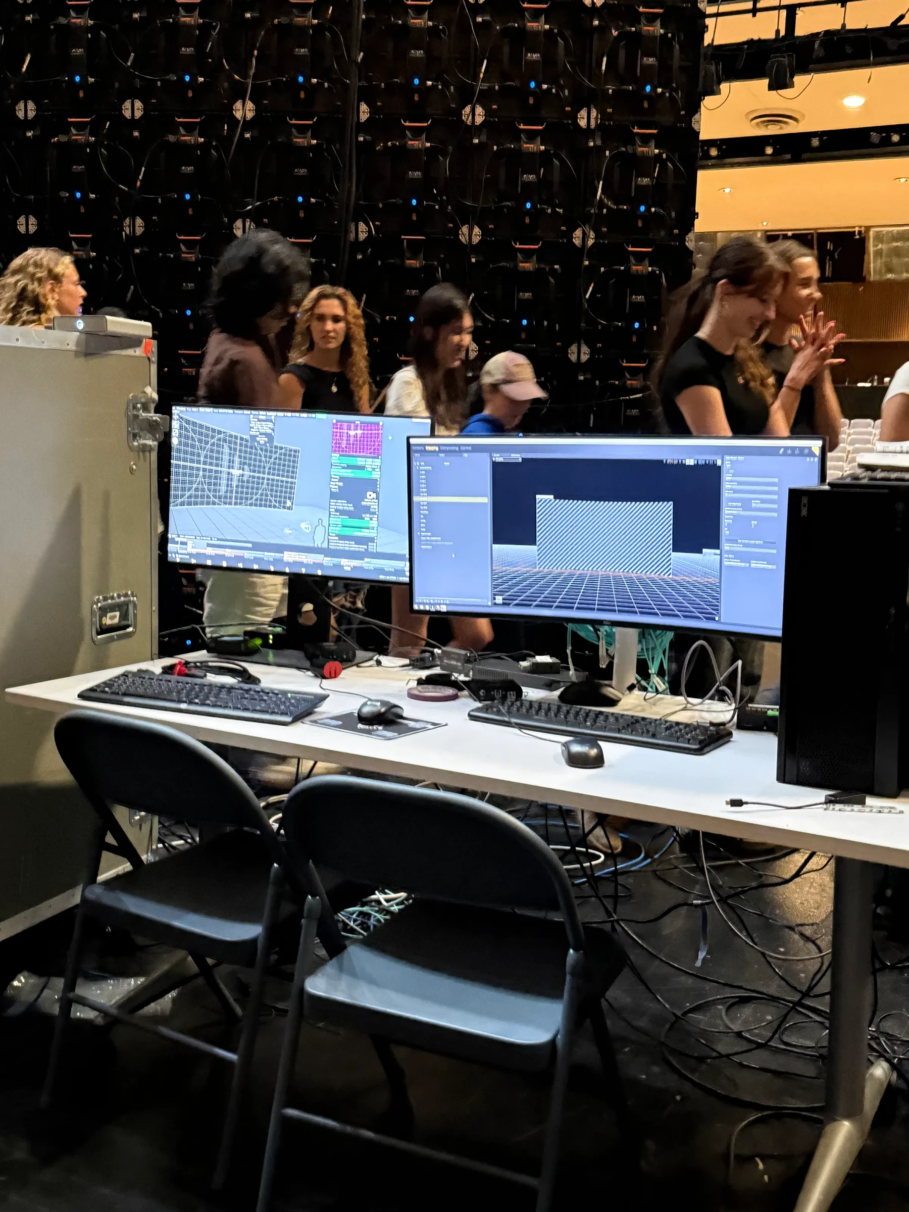 Video-production monitors and editing workstations inside a studio.