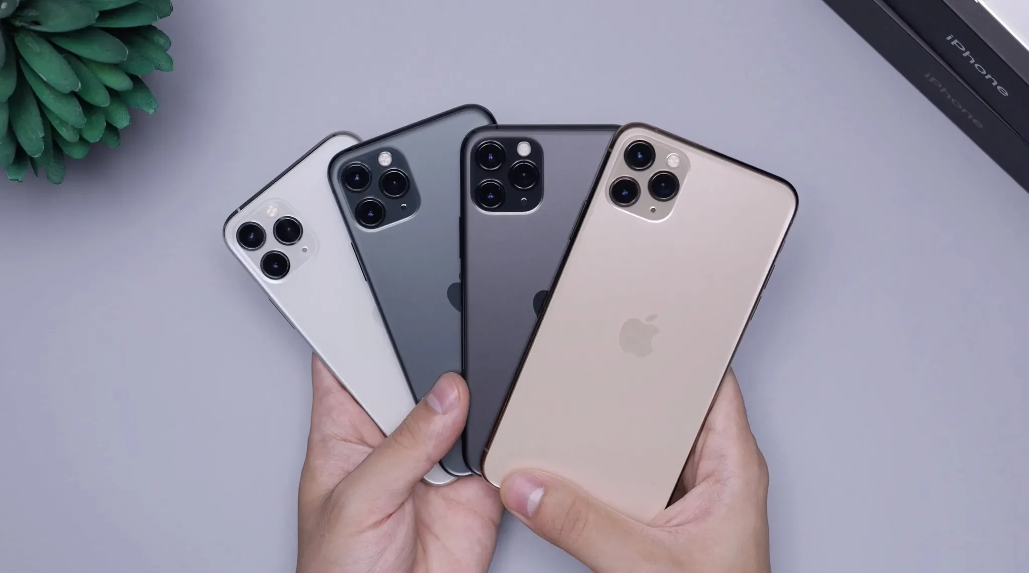Four generations of smartphones held side by side.