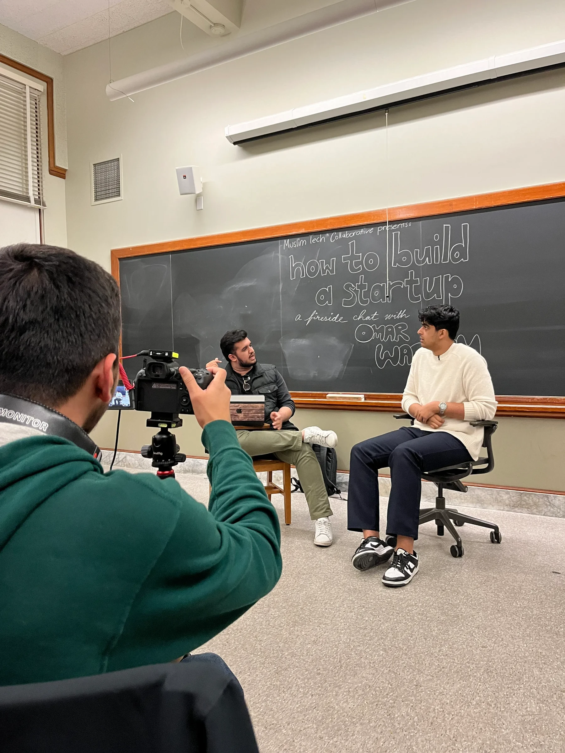 A discussion being filmed in a university classroom.