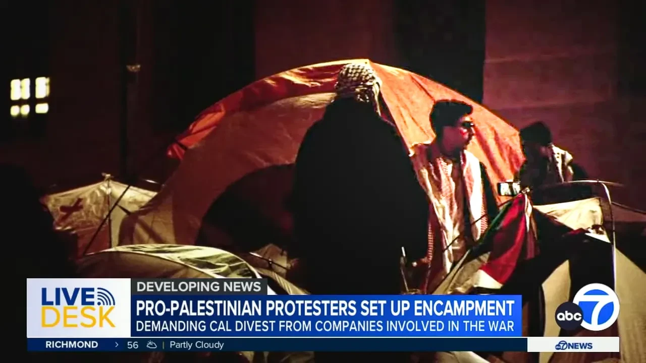 A news broadcast showing tents at a campus protest encampment.