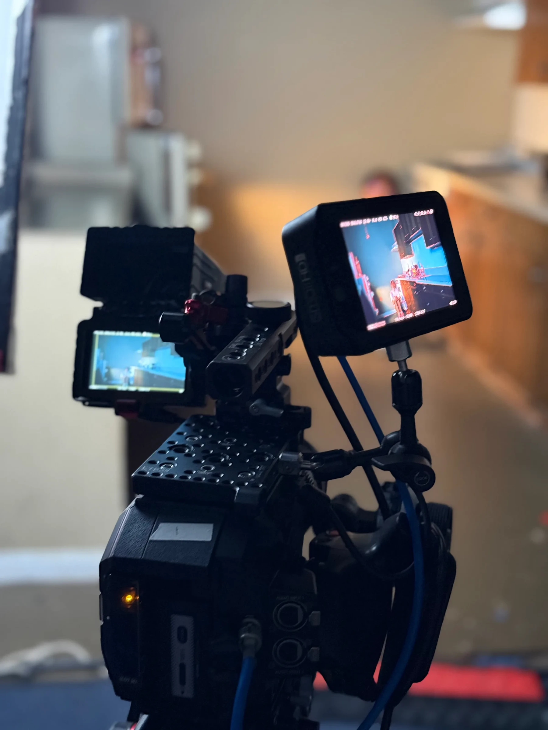 A cinema camera with two small on-set monitors.