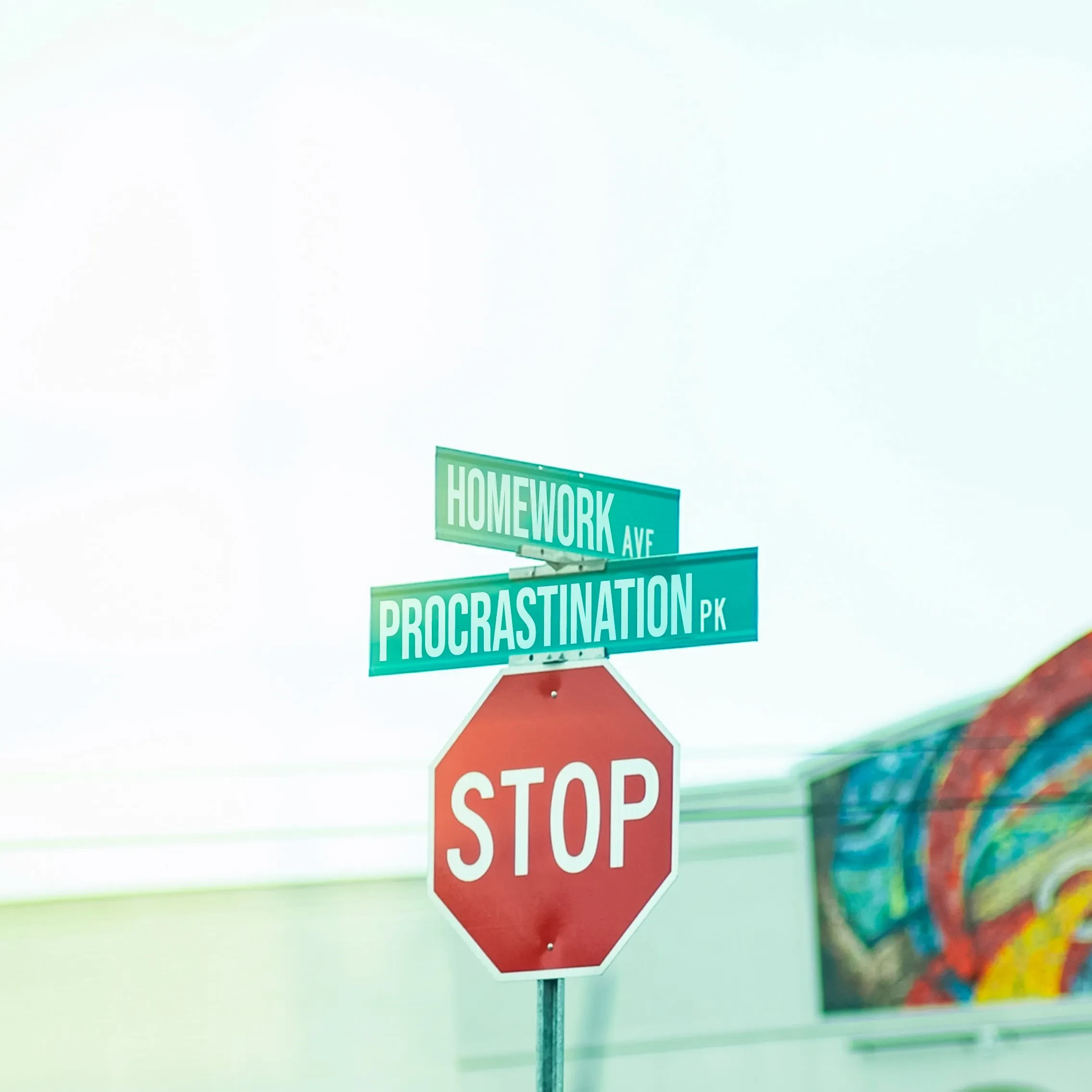 Street signs for Hardwork and Procrastination above a stop sign.