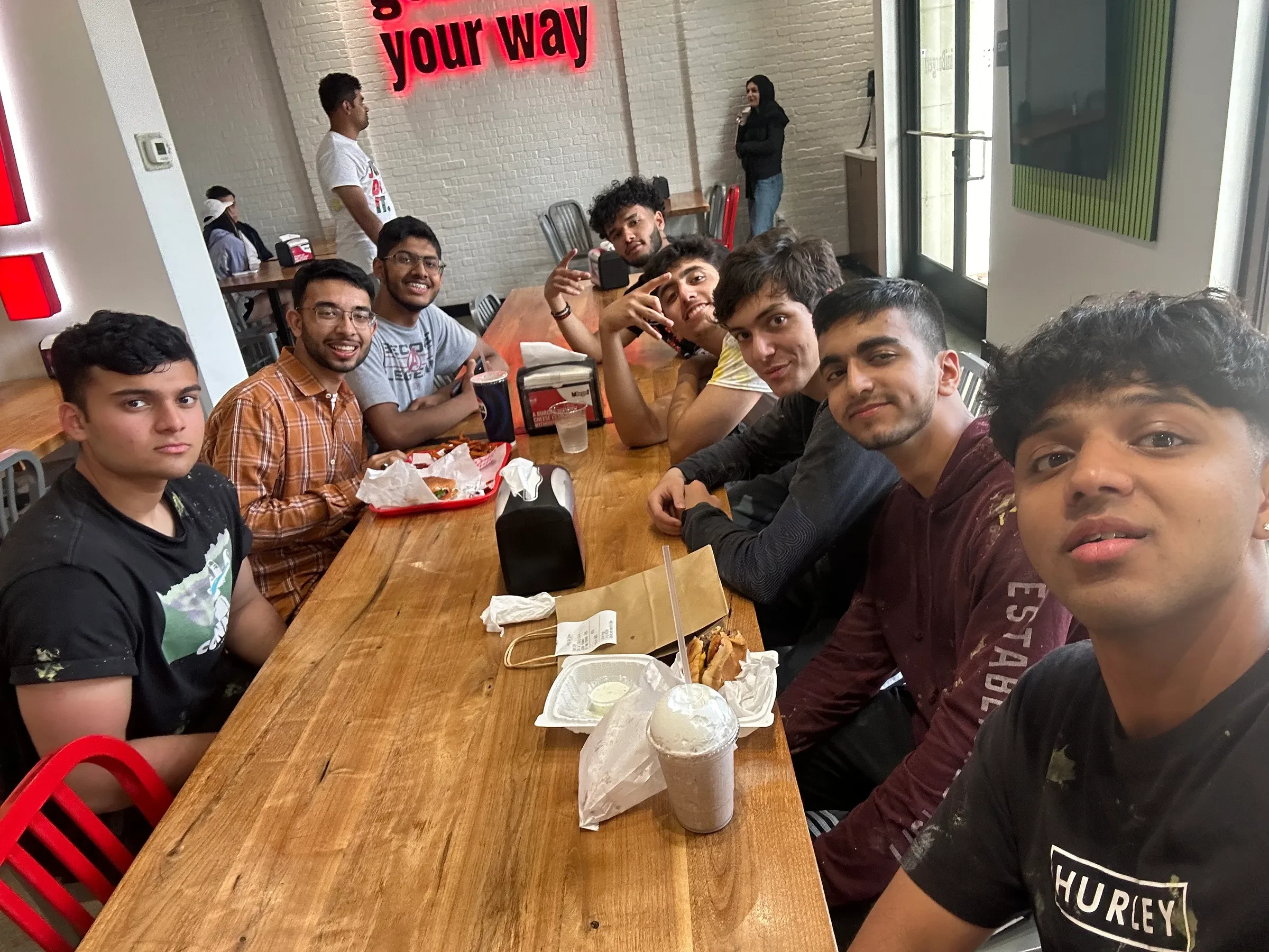 Friends gathered around a long restaurant table.