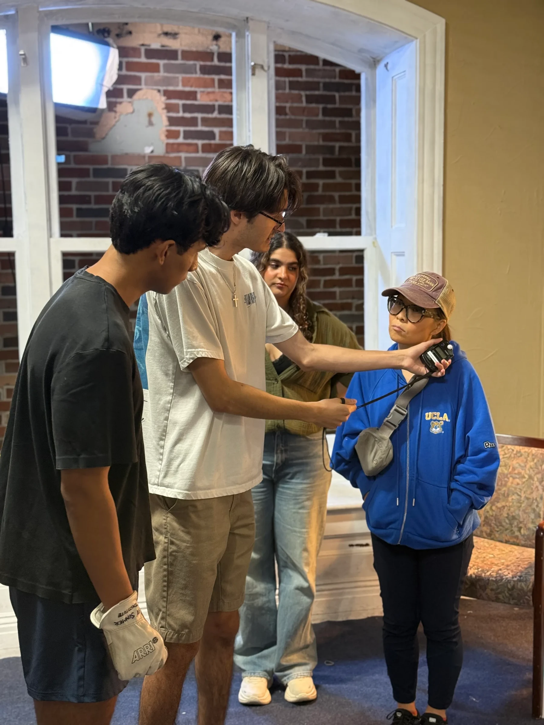 People discussing a shot beside an interior film set.